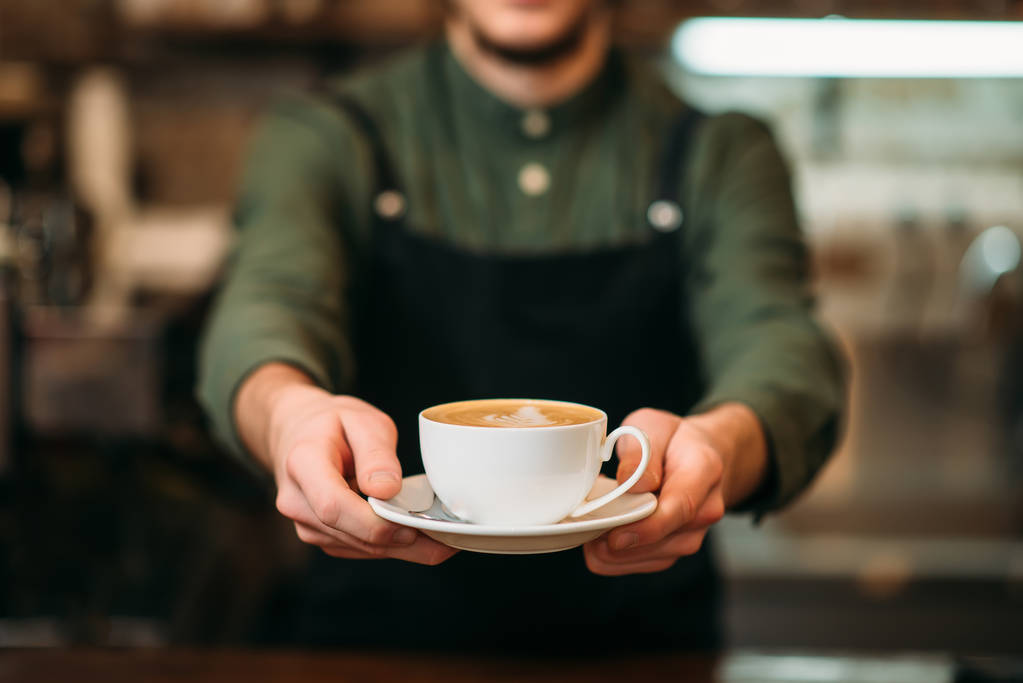 barista with coffee in hands